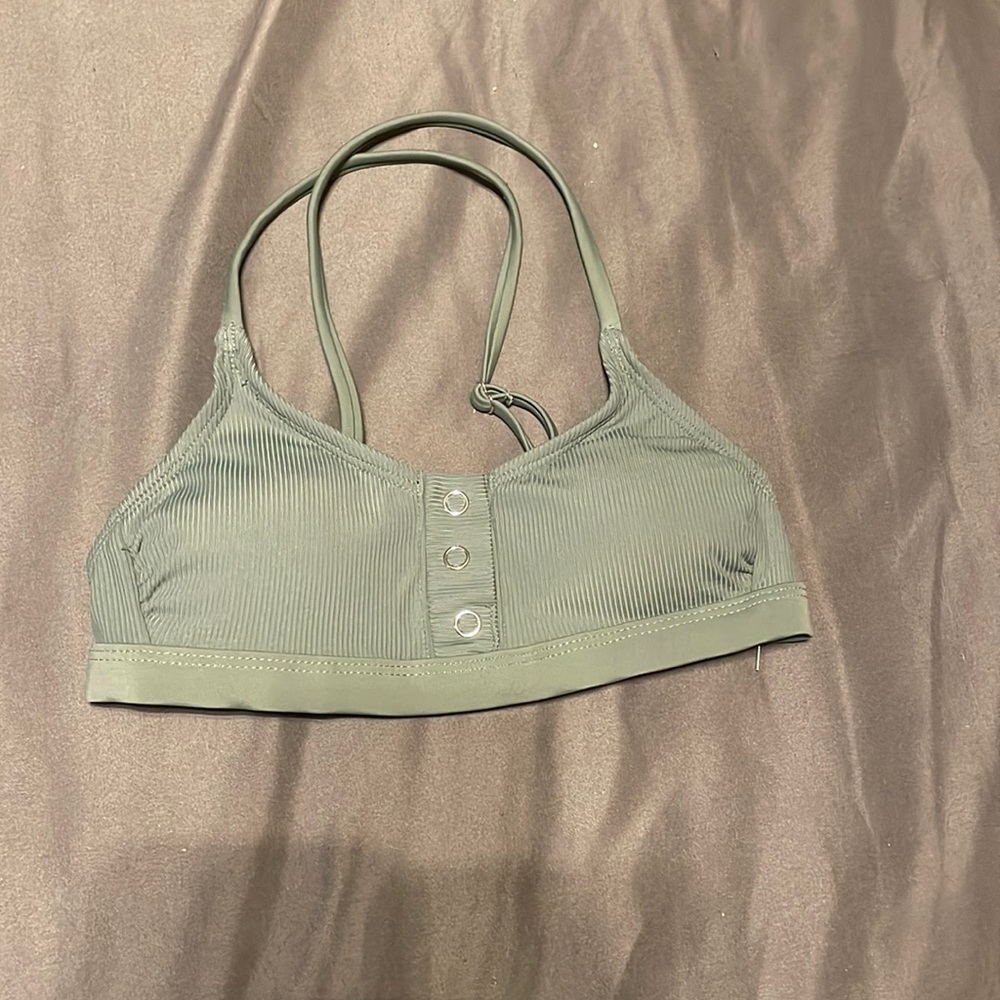 straps cross in the back. never worn.